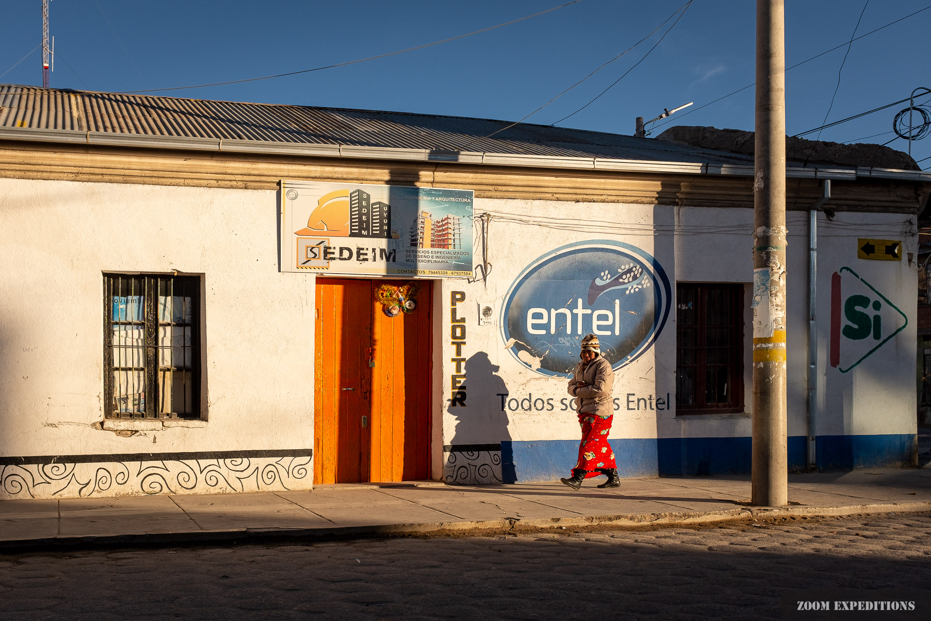 Uyuni street scene Bolivian woman in morning light