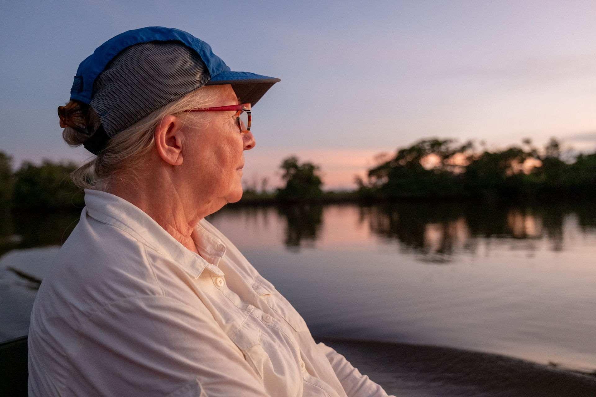 Photographer on a boat ride during sunset in Guyana.