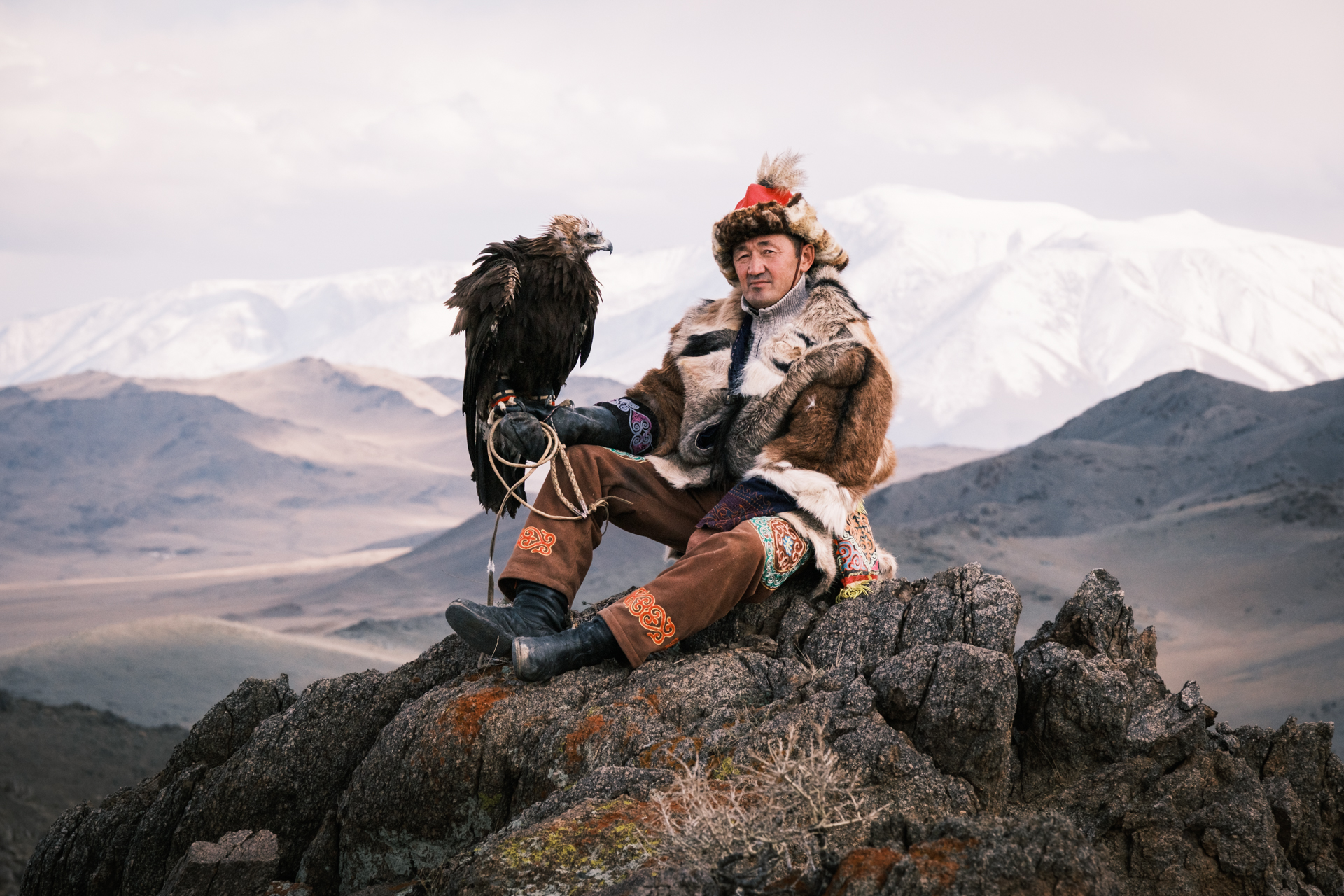 Kazakh eagle hunter with his eagle in the Altai Mountain Range.